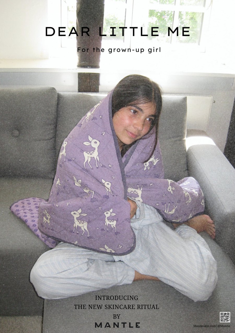 Campaign poster for Dear Little Me: a girl wrapped in a deer-print quilt on a sofa, under the headline For the grown-up girl